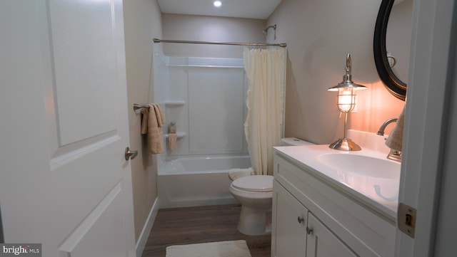 full bathroom featuring hardwood / wood-style floors, vanity, toilet, and shower / bathtub combination with curtain