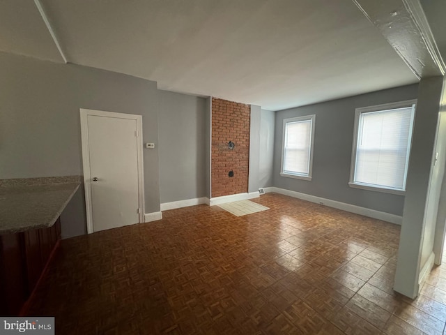 unfurnished room with parquet floors