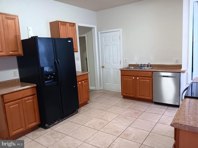 kitchen with sink, light tile patterned floors, and stainless steel appliances