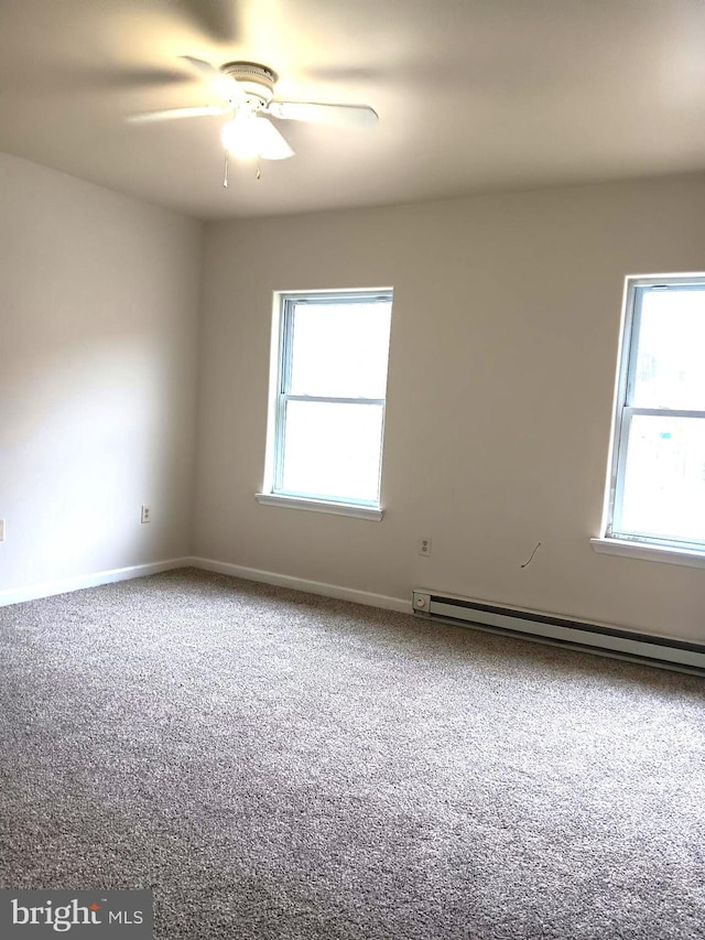 empty room with ceiling fan, a healthy amount of sunlight, and carpet floors