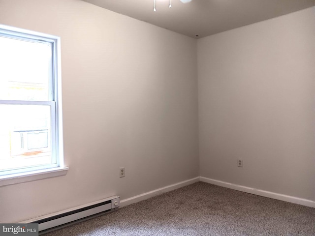 carpeted spare room with a baseboard radiator and plenty of natural light