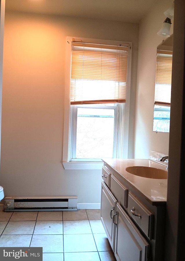 bathroom featuring tile patterned flooring, vanity, and baseboard heating