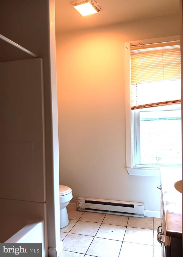 bathroom with tile patterned flooring, vanity, toilet, and a baseboard heating unit