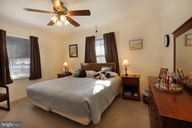 carpeted bedroom with ceiling fan and crown molding