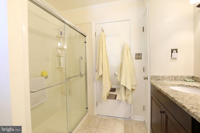 bathroom featuring vanity, tile patterned floors, crown molding, and an enclosed shower