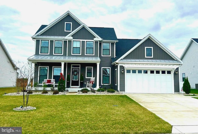 craftsman house with a porch, a garage, and a front yard