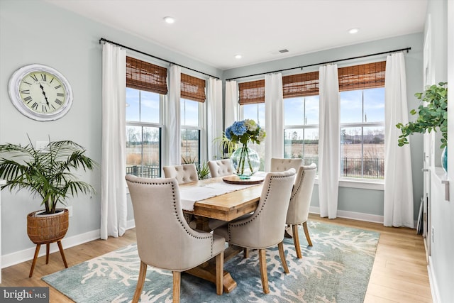 dining area with a healthy amount of sunlight and light hardwood / wood-style floors