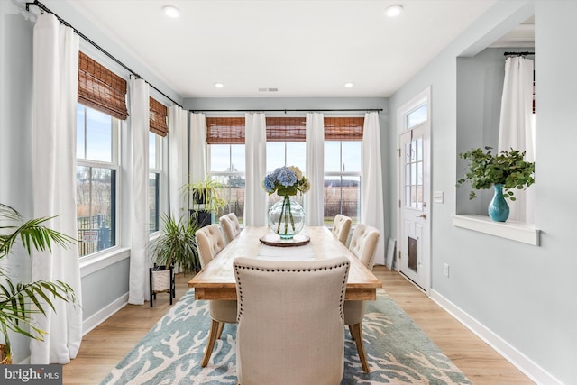 dining area with a wealth of natural light and light hardwood / wood-style floors