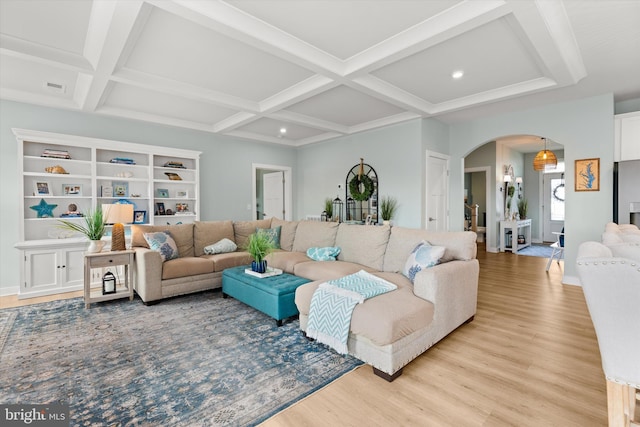 living room featuring beamed ceiling, coffered ceiling, and light wood-type flooring