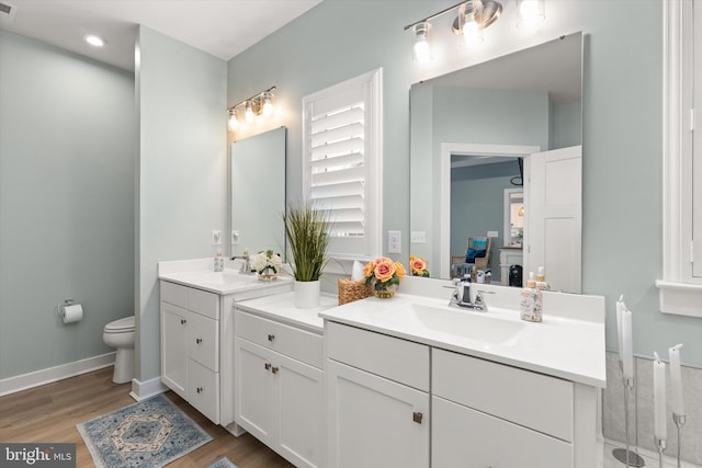 bathroom featuring vanity, hardwood / wood-style flooring, and toilet