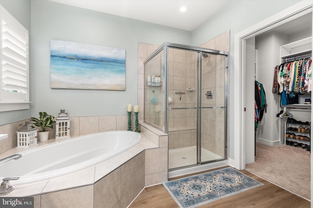 bathroom featuring independent shower and bath and hardwood / wood-style floors