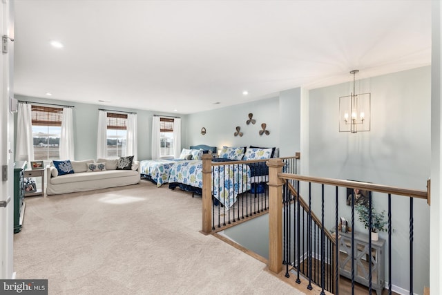 bedroom featuring light colored carpet and a chandelier