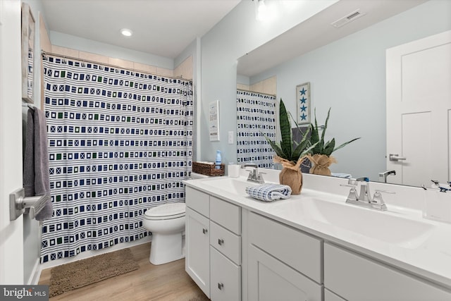 bathroom with vanity, curtained shower, wood-type flooring, and toilet