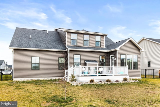 back of property featuring a wooden deck and a yard