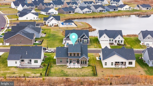 birds eye view of property with a water view