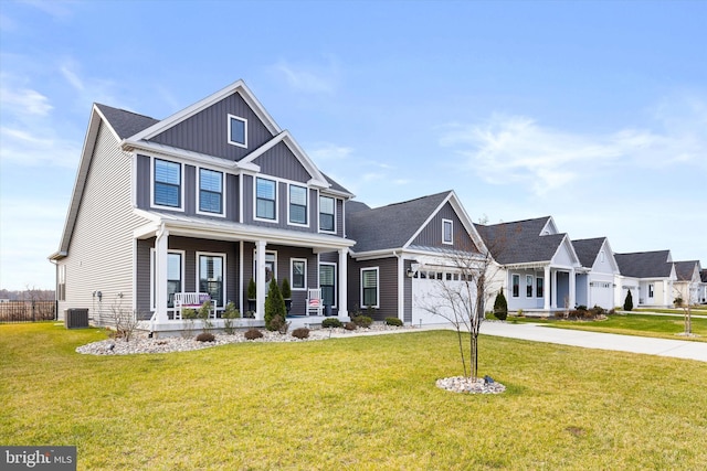 view of front of house featuring cooling unit, a garage, a front lawn, and a porch