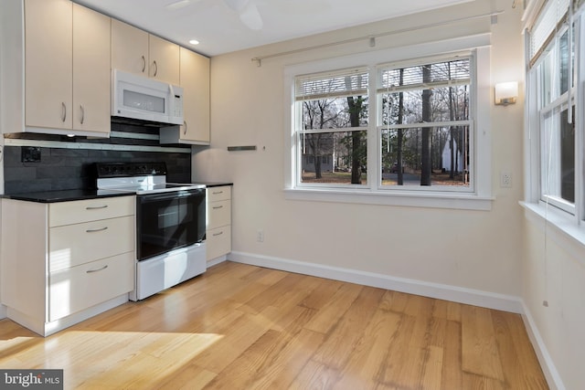 kitchen featuring decorative backsplash, ceiling fan, white appliances, and light hardwood / wood-style flooring