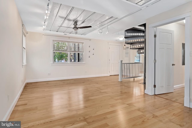 unfurnished room with ceiling fan, rail lighting, and light hardwood / wood-style flooring