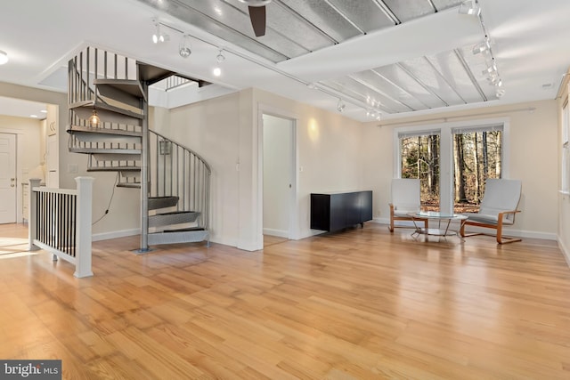 sitting room featuring ceiling fan and light wood-type flooring