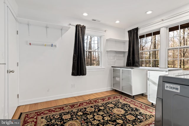 laundry room with wood-type flooring