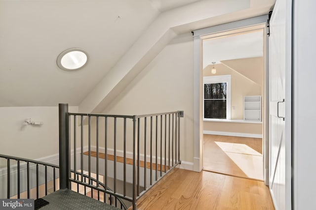 additional living space with light hardwood / wood-style flooring and vaulted ceiling