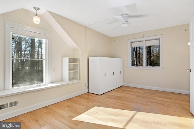 unfurnished bedroom featuring ceiling fan, light hardwood / wood-style floors, and vaulted ceiling