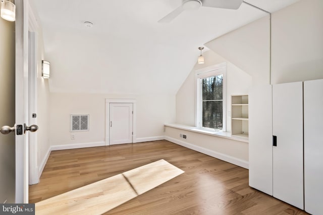 bonus room featuring ceiling fan, light hardwood / wood-style floors, and lofted ceiling