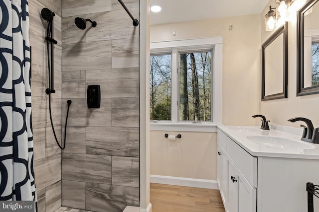 bathroom with a shower with curtain, vanity, and hardwood / wood-style floors