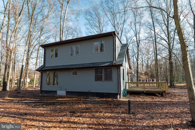 back of house with a wooden deck