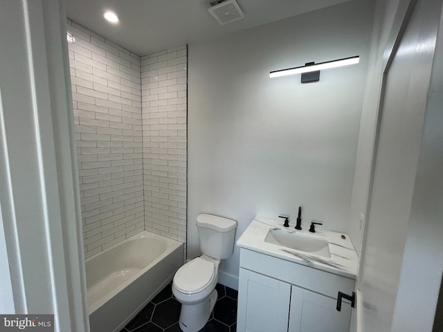 full bathroom featuring tile patterned floors, vanity, toilet, and tiled shower / bath