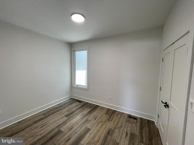 empty room featuring dark hardwood / wood-style flooring