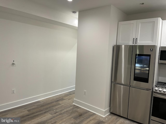 kitchen featuring hardwood / wood-style flooring, white cabinetry, and appliances with stainless steel finishes