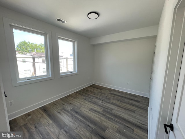 spare room featuring dark hardwood / wood-style flooring