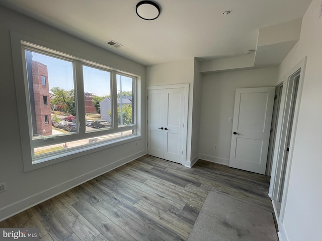 unfurnished bedroom with light hardwood / wood-style floors and a closet