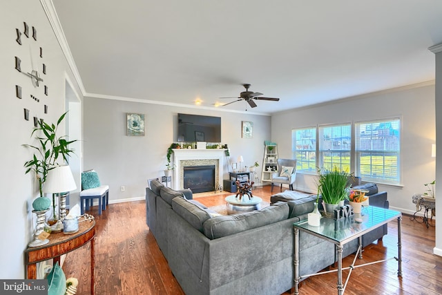 living room with hardwood / wood-style flooring, ceiling fan, and ornamental molding