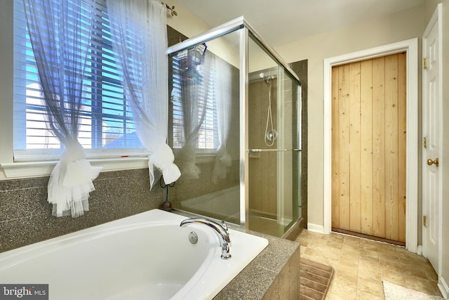 bathroom featuring shower with separate bathtub