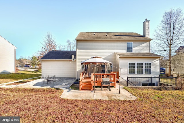 back of property featuring a gazebo, a patio, and a lawn