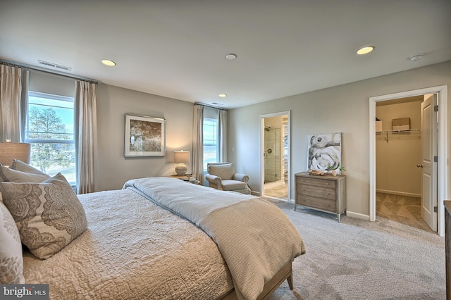 Skyview Dr W, Lavale, MD 21502 - bedroom with multiple windows, a walk in closet, recessed lighting, light colored carpet, and connected bathroom