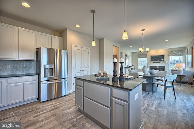 Skyview Dr W, Lavale, MD 21502 - kitchen featuring stainless steel fridge, wood finished floors, a center island, tasteful backsplash, and dark stone counters
