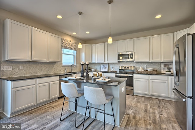 Skyview Dr W, Lavale, MD 21502 - kitchen with appliances with stainless steel finishes, light wood finished floors, white cabinets, backsplash, and recessed lighting