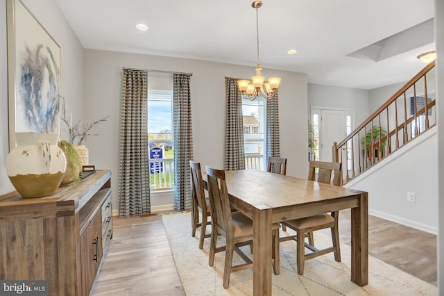 dining space with a chandelier and light wood-type flooring