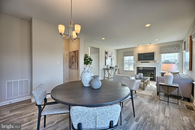 Skyview Dr W, Lavale, MD 21502 - dining area featuring wood finished floors, a glass covered fireplace, a chandelier, and recessed lighting