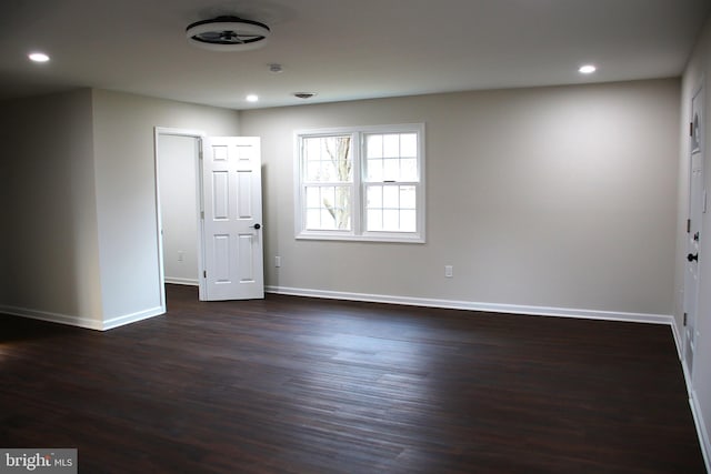 spare room with dark wood-type flooring