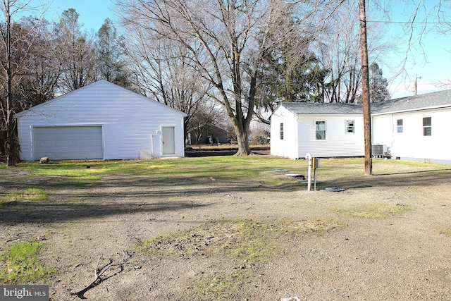 exterior space featuring an outbuilding, a garage, and central AC unit