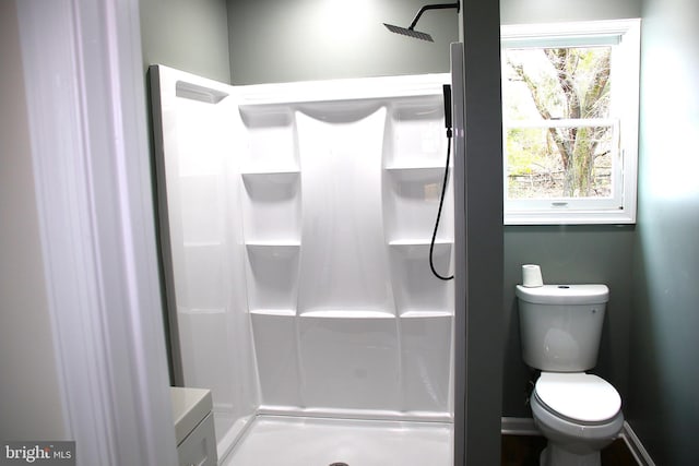 bathroom featuring toilet and walk in shower