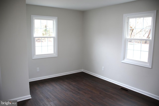 spare room featuring dark hardwood / wood-style floors