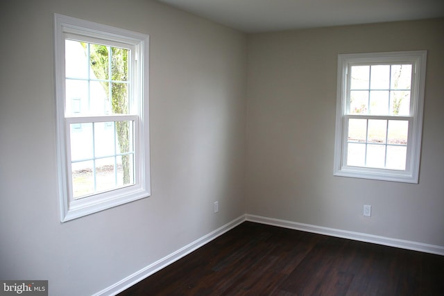 spare room featuring dark hardwood / wood-style flooring