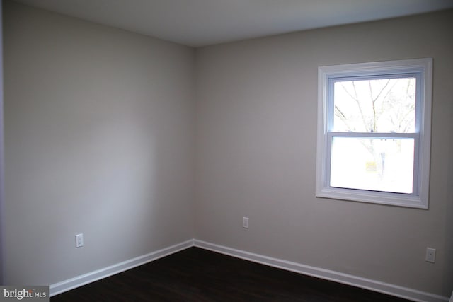 unfurnished room with dark hardwood / wood-style floors