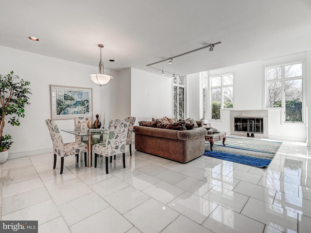 dining room with a high end fireplace, light tile patterned flooring, baseboards, and recessed lighting