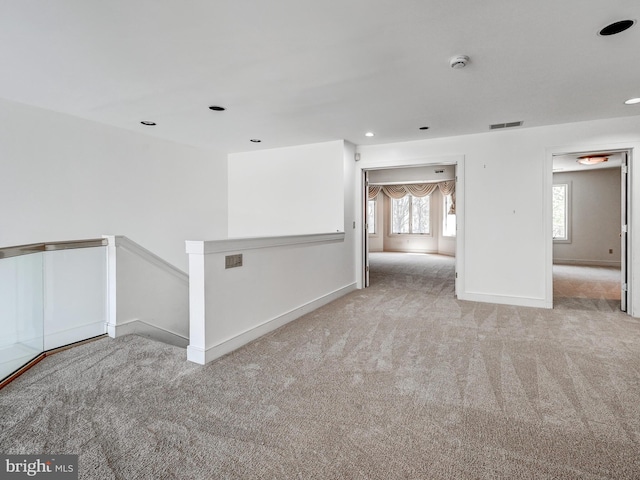 spare room featuring carpet, visible vents, baseboards, and recessed lighting